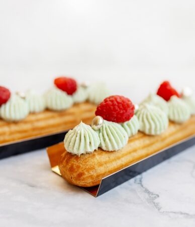 beautiful,eclairs,on,a,light,marble,background.,delicious,pastries,close up.